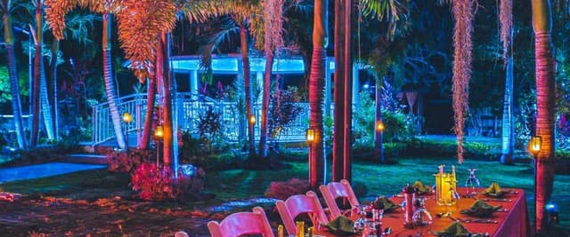 Ladies on retreat in Jamaica having dinner on roof deck at Mais Oui Villa
